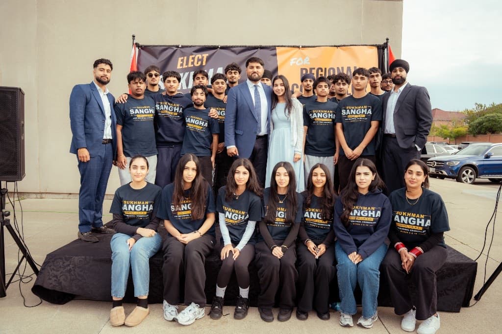 Sukhman Sangha with campaign volunteers wearing Sangha campaign shirts